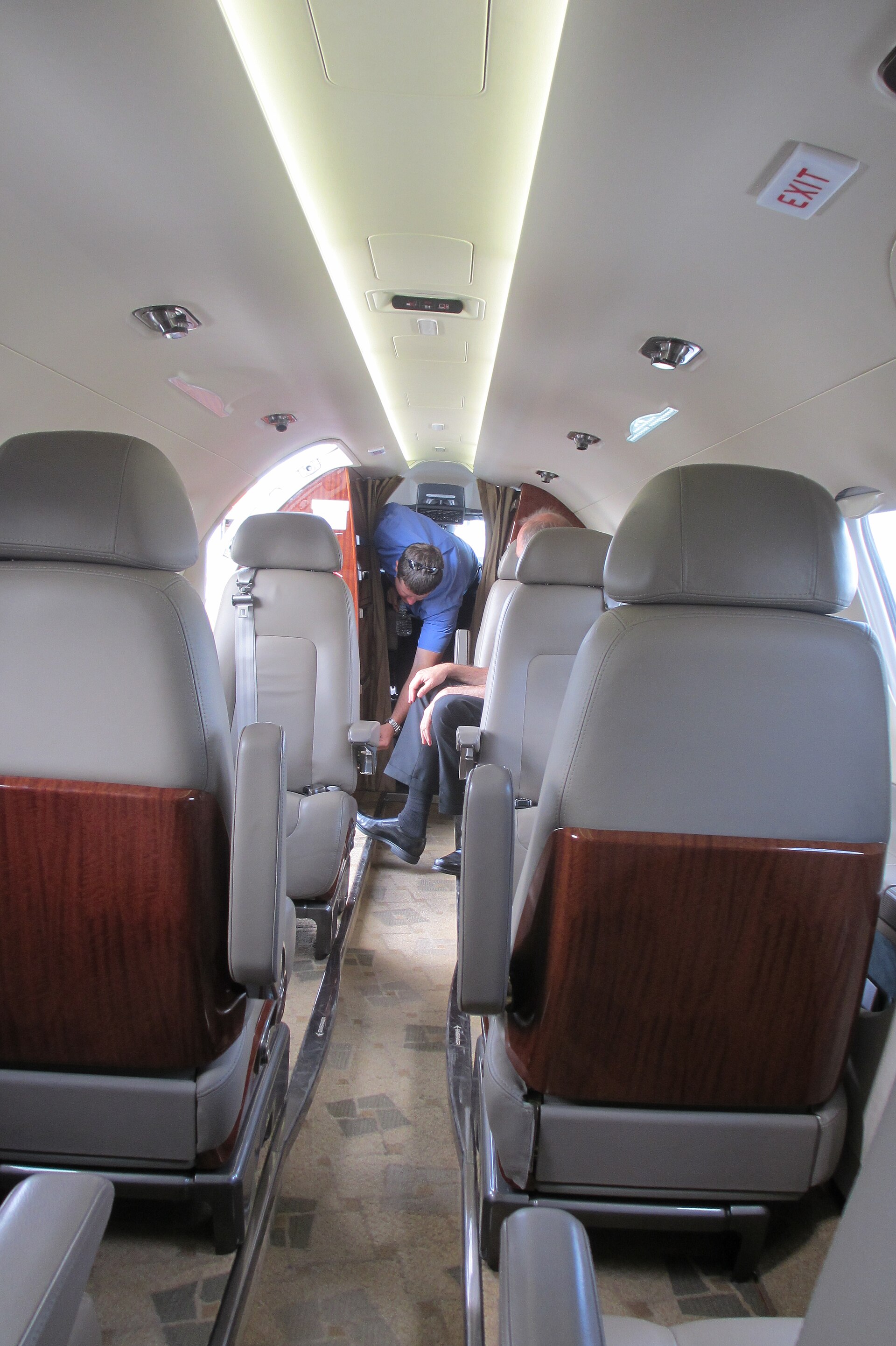 Embraer Phenom 300 light jet cabin with passengers seated facing each other