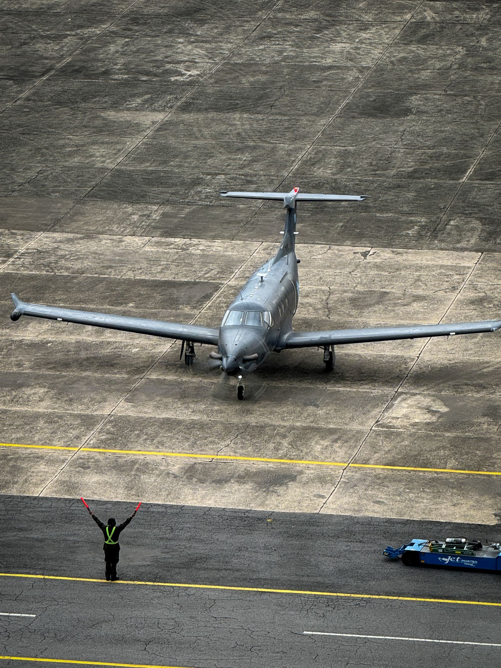 Ground crew marshaling a private jet on the runway