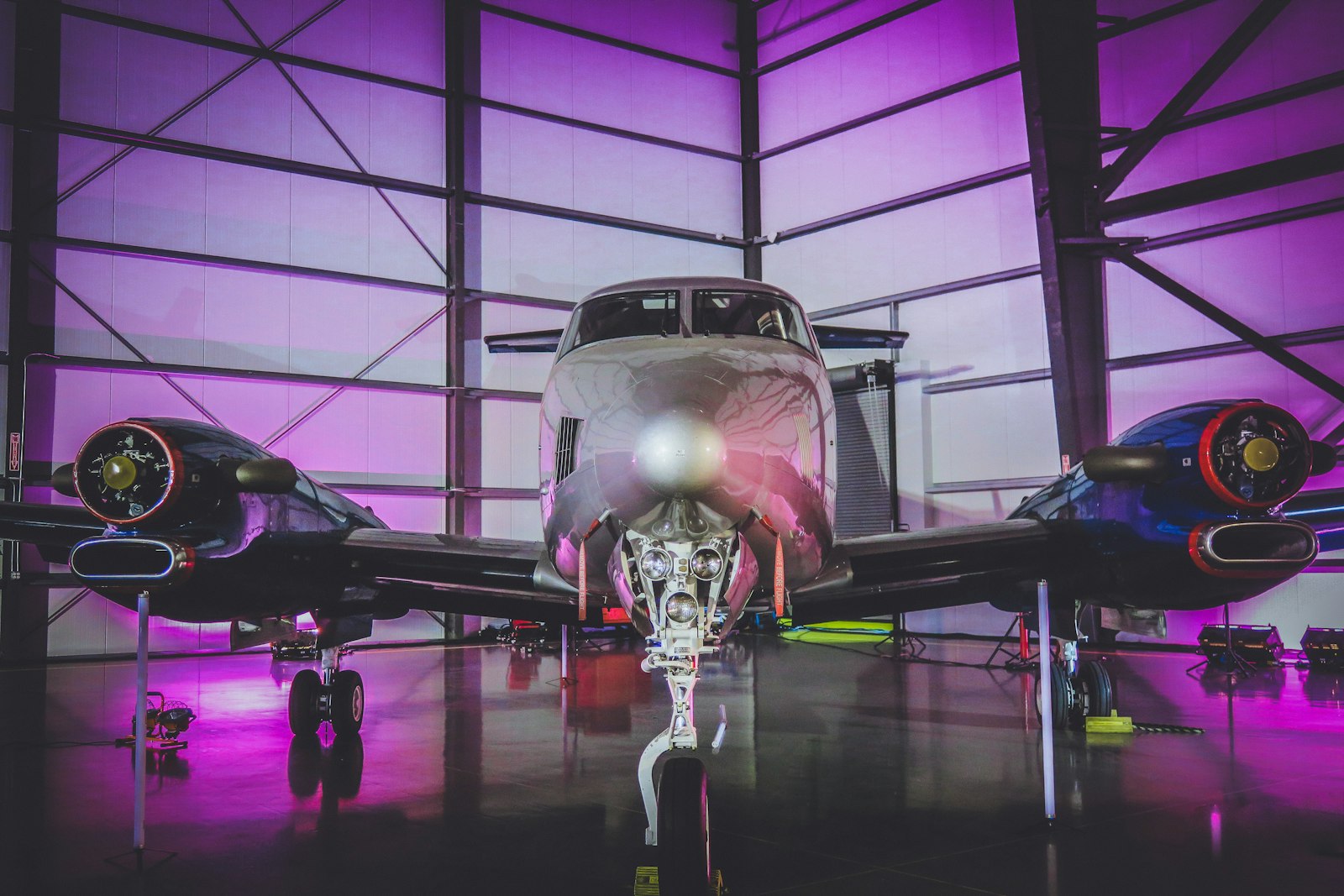 White private jet parked inside an aircraft hangar