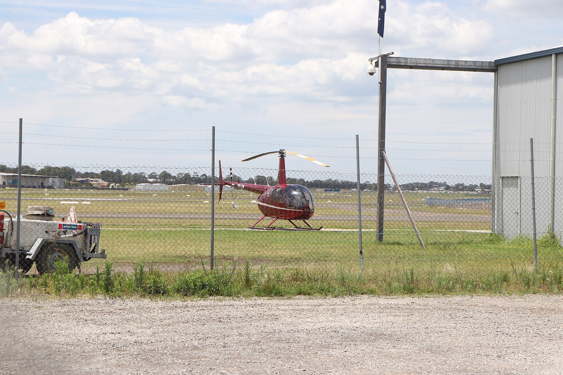 Robinson R44 light single-engine helicopter parked on grass